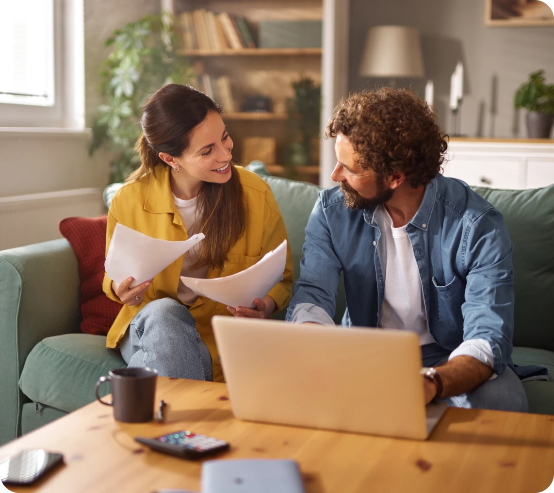Couple discussing documents on the couch